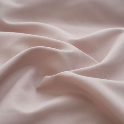 Close-up of the smooth Mocha Sand sheet set fabric texture